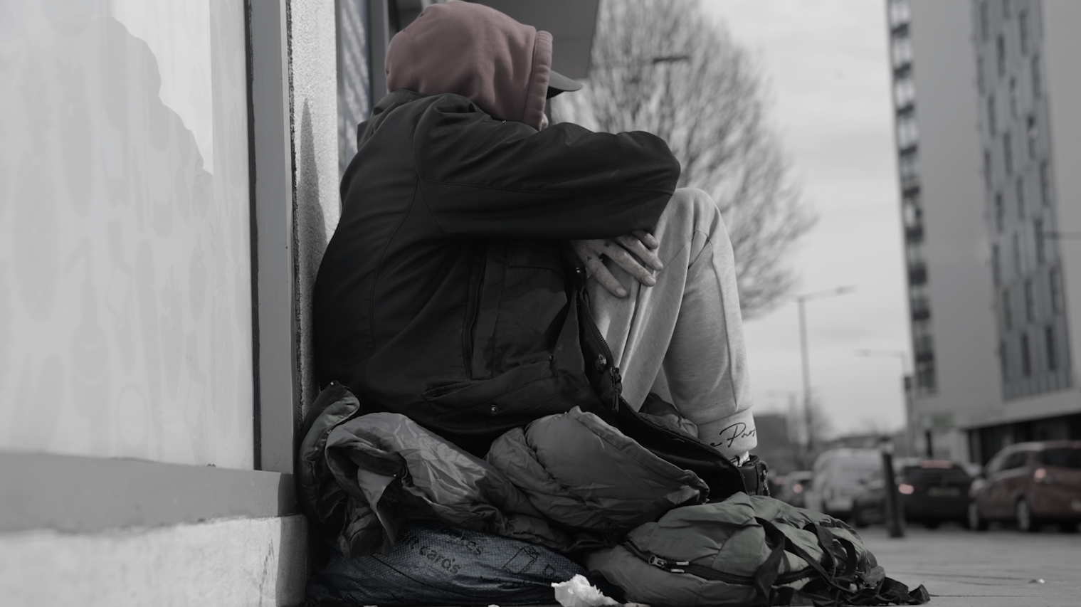 Image shows homeless person on city street